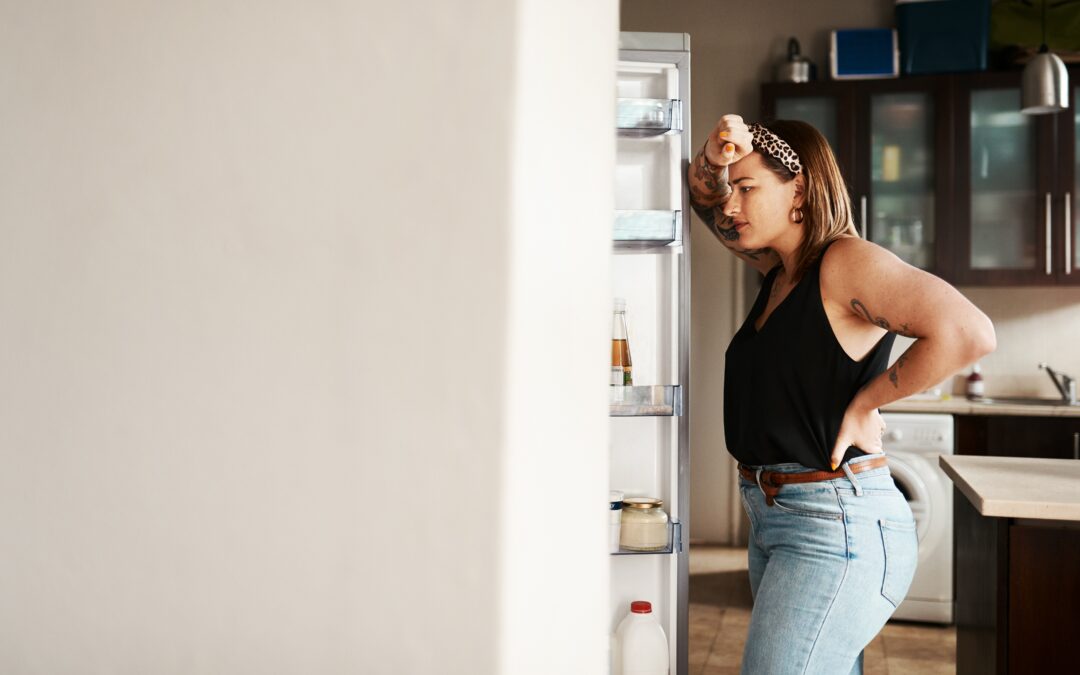 hungry woman looking in a fridge