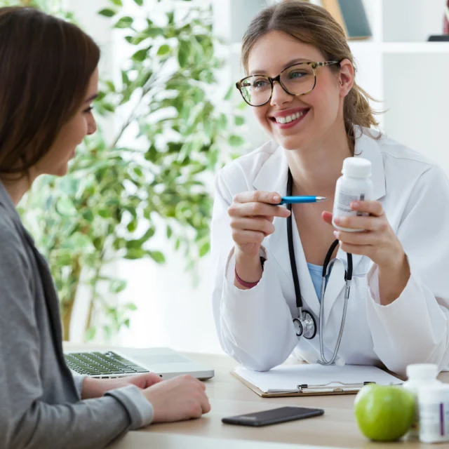 A doctor showing a patient a medication.