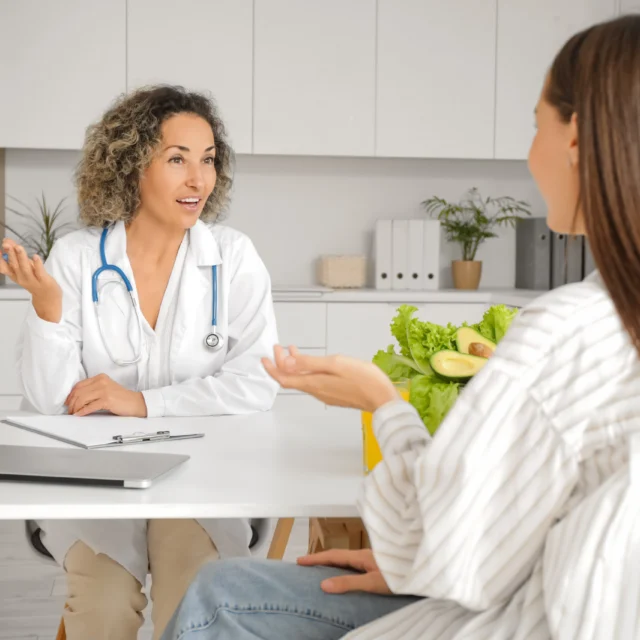 A doctor and patient in the middle of a consultation.