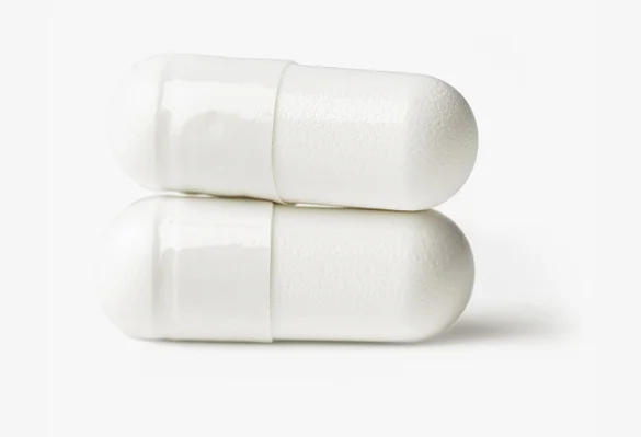 Two white capsules stacked horizontally on a plain white background.
